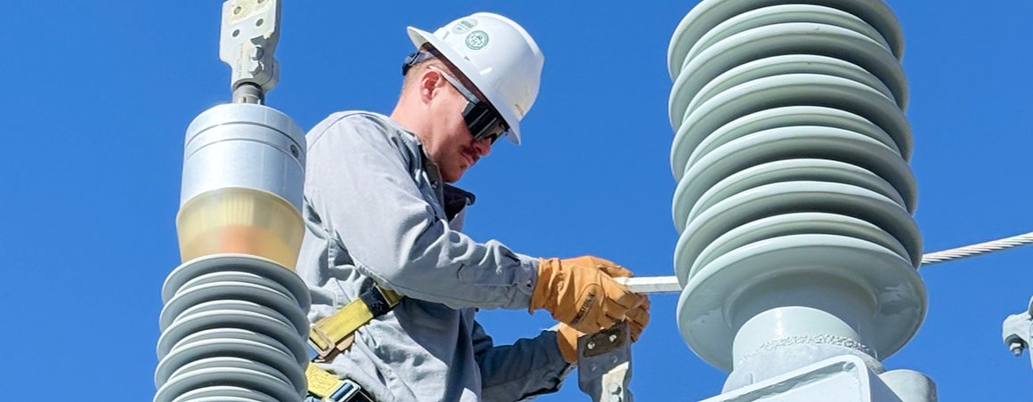 Technician testing a high-voltage insulator stack